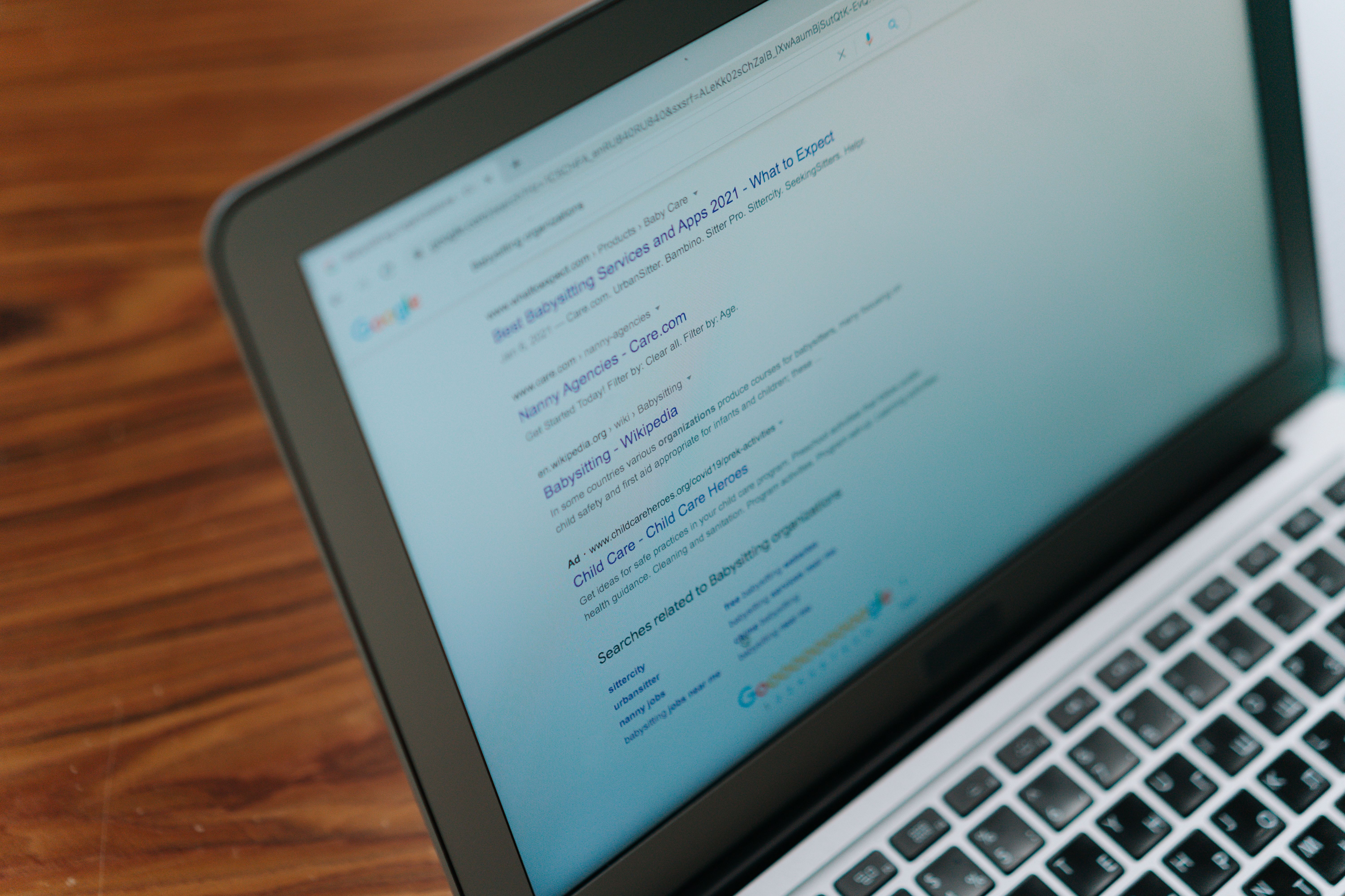 Close-up of a laptop showing search engine results pages where ranking is influenced by backlinks