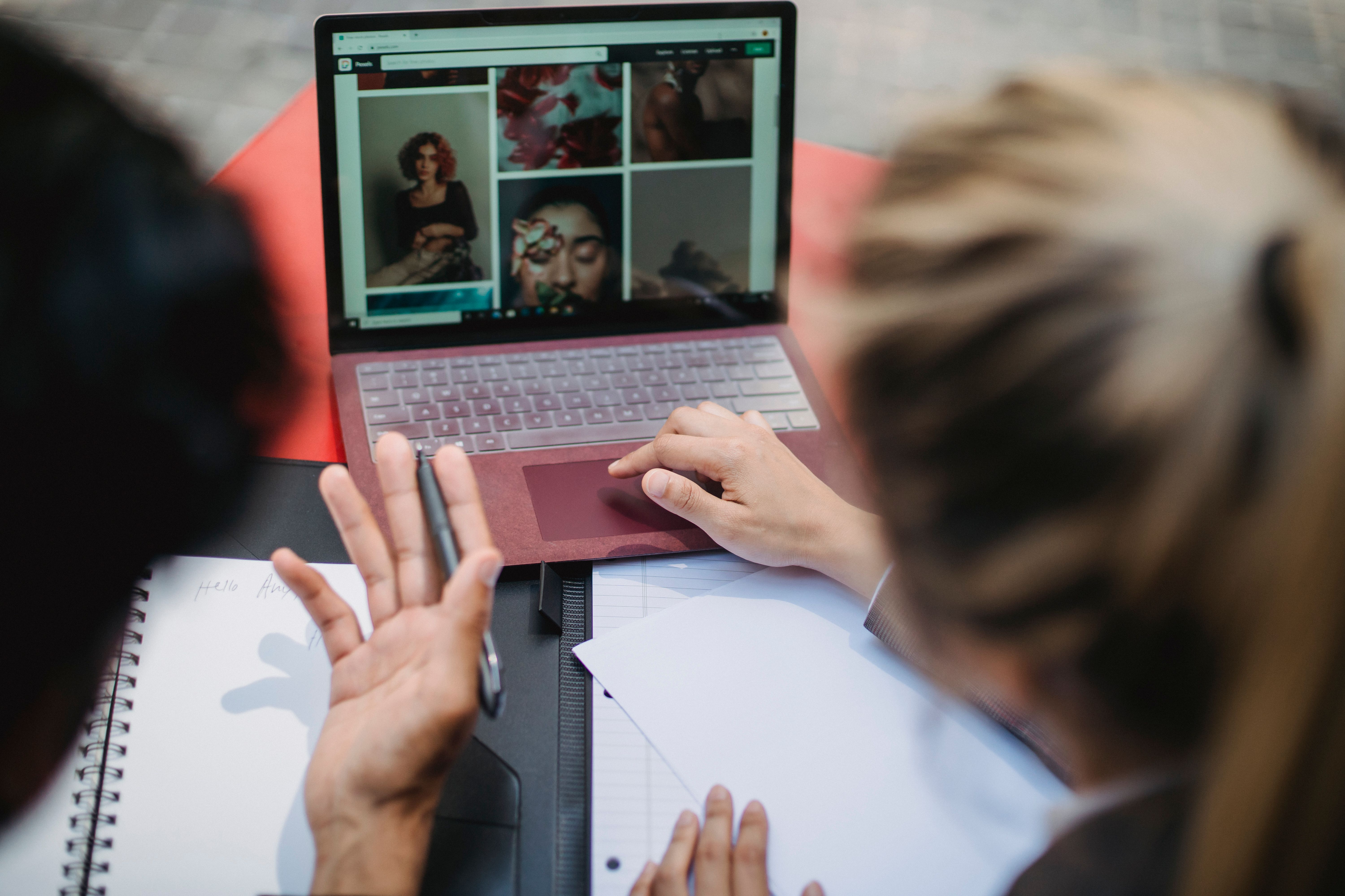Two people collaborating on a laptop, representing outreach and guest posting for link building